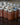 Numerous sealed Mason jars filled with homemade apple butter arranged in neat rows on a wooden table