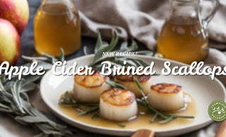  A new recipe for apple cider-bined scallops. The image shows the finished dish, scallops with a sauce, served with sage.