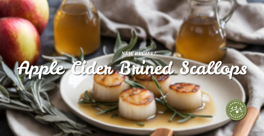  A new recipe for apple cider-bined scallops. The image shows the finished dish, scallops with a sauce, served with sage.